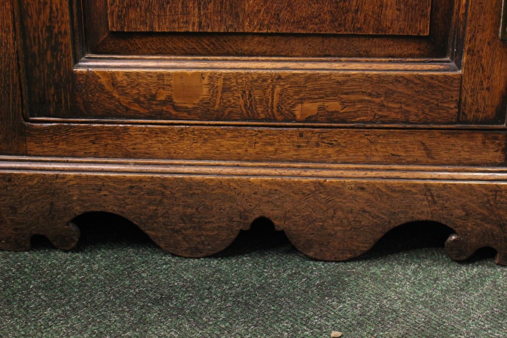 AN OAK HANGING CORNER CUPBOARD, straight fronted, with fluted cornice over a carved panel door, - Image 2 of 3