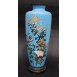 A BLUE CLOISONNE VASE, depicting birds & honeysuckle flowers, brass rim to the base, with mark