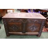 A 17TH CENTURY OAK "COFFER"/CHEST, with deep oak patination, below the lid runs a band of carved