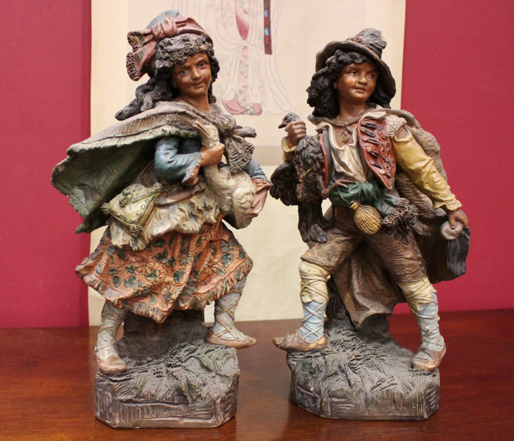 A PAIR OF “BISQUE” CERAMIC FIGURINES, (1) A peasant girl holding a goose, (1) A peasant boy