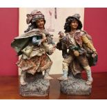 A PAIR OF “BISQUE” CERAMIC FIGURINES, (1) A peasant girl holding a goose, (1) A peasant boy
