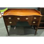 A VERY FINE SERPENTINE SHAPED SIDE BOARD, with 5 drawers, canted front corners, raised on tapering