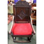 AN OAK “WAINSCOT” ARMCHAIR, with square panel back, having carved top rail, and lozenge shaped