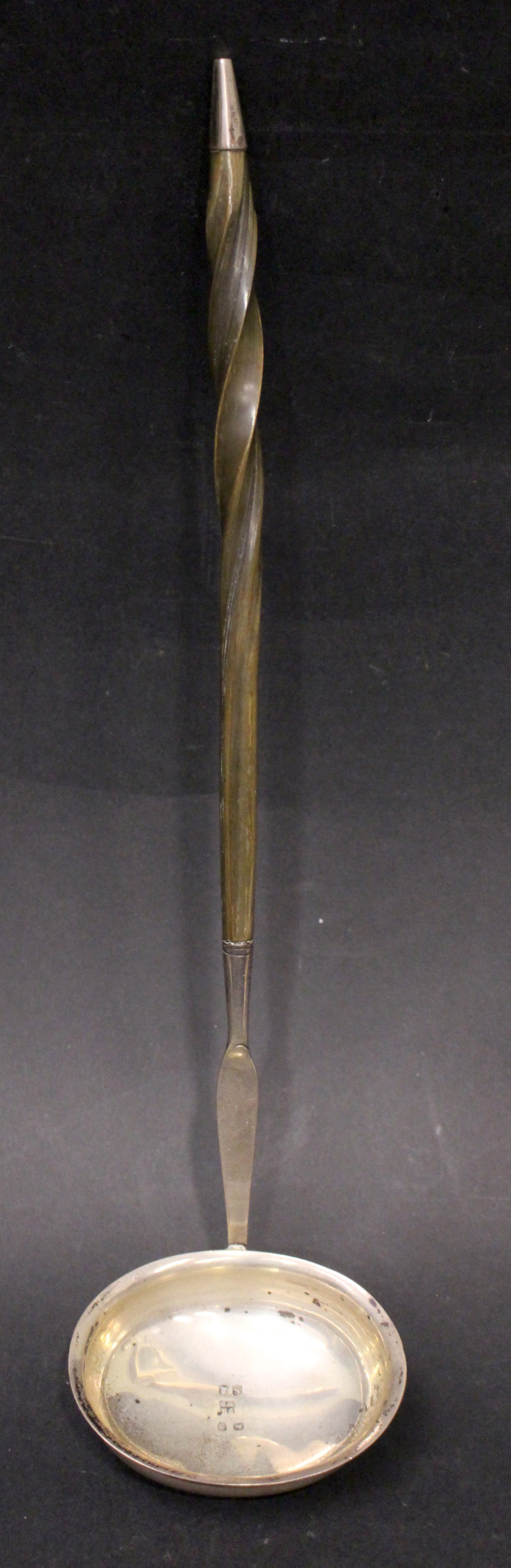 AN EARLY 19TH CENTURY ENGLISH SILVER LADLE, with twisted ‘Baleen’/bone handle, tipped with silver,
