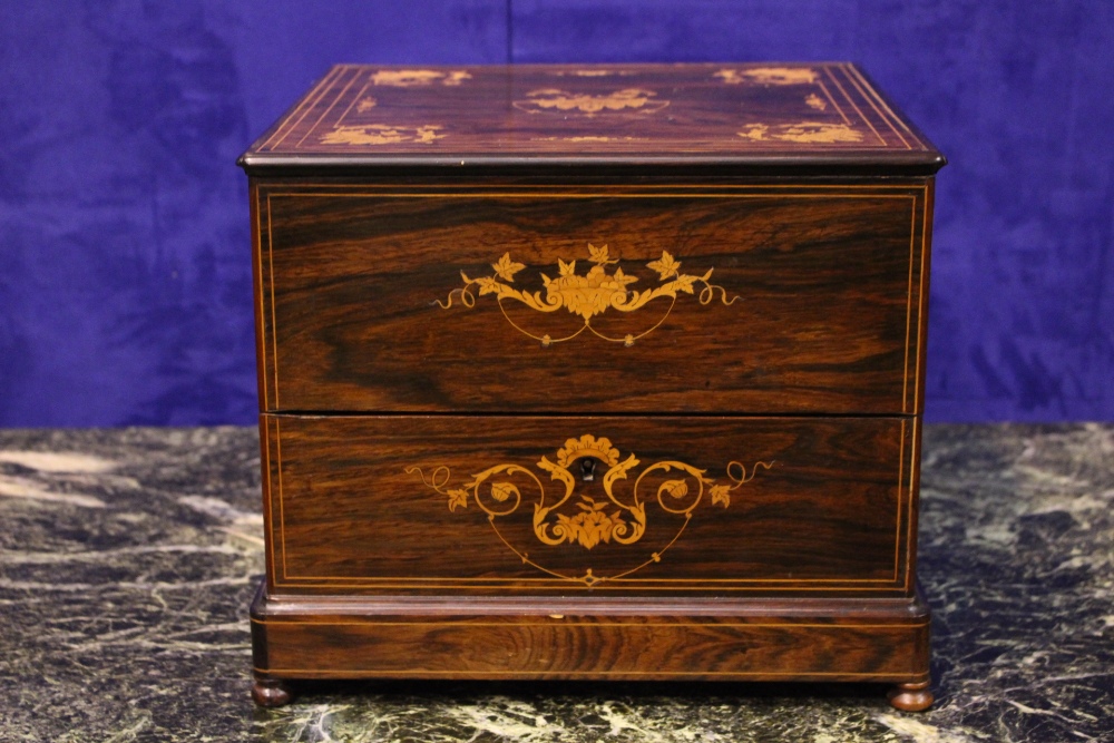 A ROSEWOOD DECANTER BOX, with satinwood inlaid detail, hinged lid opens to reveal four cut glass