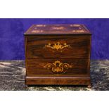 A ROSEWOOD DECANTER BOX, with satinwood inlaid detail, hinged lid opens to reveal four cut glass