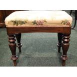 A DRESSING STOOL, raised on tapering turned legs, with stuffed over seat, 21" x 12" x 17.5" approx