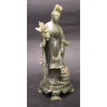 A GREEN JADE CARVED FIGURE OF A FEMALE FIGURE, early 20th Century, shown wearing belted robes,