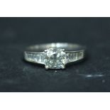 AN 18CT WHITE GOLD SOLITAIRE RING, with baguette shoulders, centre stone 1.00 cwts