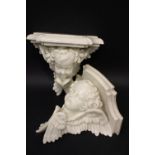 A PAIR OF 19TH CENTURY PORCELAIN "CHERUB" WALL BRACKET SHELVES