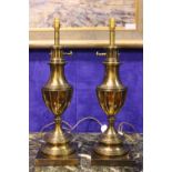 A PAIR OF BRASS LAMPS, 26" tall, with tiered base, graduated body with broad fluted shaped,