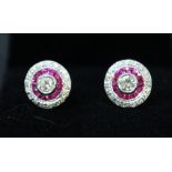 A PAIR OF 18CT WHITE GOLD RUBY & DIAMOND, "target" earrings, art deco style