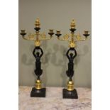 A PAIR OF EMPIRE STYLE CANDELABRA, in the form of a woman holder her arms aloft, each with two arms,