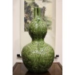A LARGE TRILOBED DOUBLE GOURD VASE, with a green glaze having fine crackling, showing three mystical