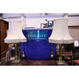 A PAIR OF LARGE BRASS CORINTHIAN STYLE TABLE LAMPS, with shades, electric