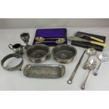 A pair of silver plated bottle coasters, a cased set of spoons, and various other silver plated