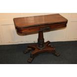 A Victorian rosewood pedestal card table with rectangular red baize lined top, carved anthemion