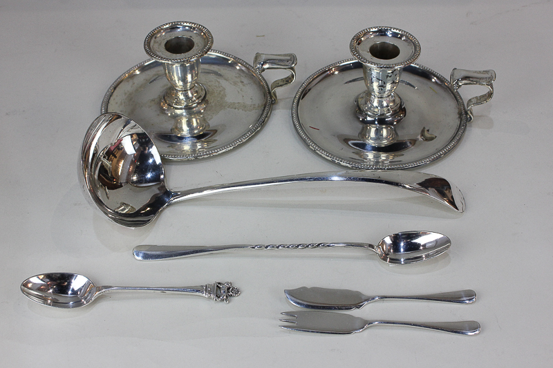 A pair of silver plated chamber sticks, a Christofle sundae spoon, a soup ladle, a pair of