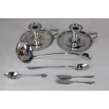 A pair of silver plated chamber sticks, a Christofle sundae spoon, a soup ladle, a pair of