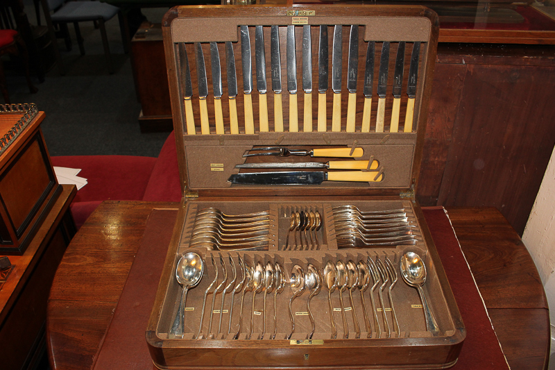 A part canteen of silver plated cutlery, Old English pattern with rattail bowls, in walnut case