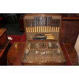 A part canteen of silver plated cutlery, Old English pattern with rattail bowls, in walnut case