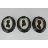 A pair of oval silhouette profile portraits, of a gentleman and a lady, 7.5cm by 5.5cm, and an