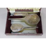 A George VI silver four-piece cased dressing table set, of two brushes, hand mirror and comb (some