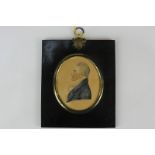 A mid-19th century oval miniature portrait profile of a gentleman, in white jabot and blue coat,