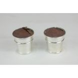 A pair of George VI silver pots, Birmingham, 1938, marks worn, base marked Wilson & Gill London,