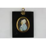 A 19th century oval portrait profile of an old lady, in a white cap and blue shawl, on ivory, 6cm by