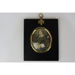 A late 19th century oval miniature portrait of a lady, in blue gown trimmed with white lace, on