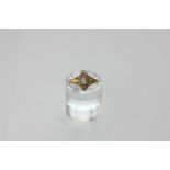 A diamond cluster ring navette shape set with a central old cut stone within a rose diamond border