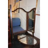 A mahogany three panel dressing table mirror, with central oval adjustable mirror, on curved feet,