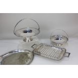 Two silver plated circular baskets with pierced borders, swivel handle, on pedestal base, largest