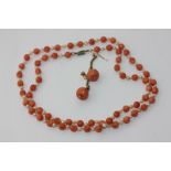 A coral bead and pearl necklace on a rose diamond set gold clasp; and a pair of coral drop earrings