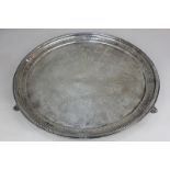 A Victorian silver circular salver with engraved floral swag decoration and pierced border, on three