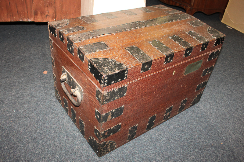 A metal bound oak silver chest with side handles and vacant brass plaque, with green baize lined