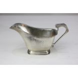 An Edward VIII Art Deco silver cream jug on rectangular foot, maker William Neale, Birmingham