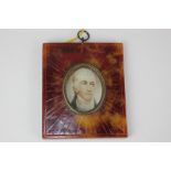 A late 18th century oval miniature portrait of a gentleman, with white necktie, on ivory, 4.1cm by