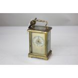 A gilt brass and bevelled glass cased carriage clock, the circular silvered dial with gilt
