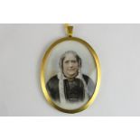 A late 19th century oval miniature portrait of an old lady, in white lace cap and collar and a black