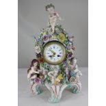 An ornate 19th century Dresden porcelain mantel clock, the porcelain case in the style of Meissen,