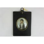 A late 19th century oval miniature portrait of a gentleman, in white necktie and fur trimmed jacket,