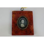 A late 18th century oval miniature portrait of a lady, wearing a black choker, 3.7cm by 3.1cm