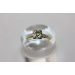 An old cut diamond single stone ring the cushion cut stone four claw set