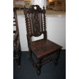 A carved oak hall chair, with foliate pierced back and floral carved hard seat, with barley twist