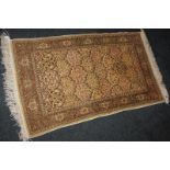 A Persian design small silk rug, floral lattice design on cream ground, 110cm by 64cm