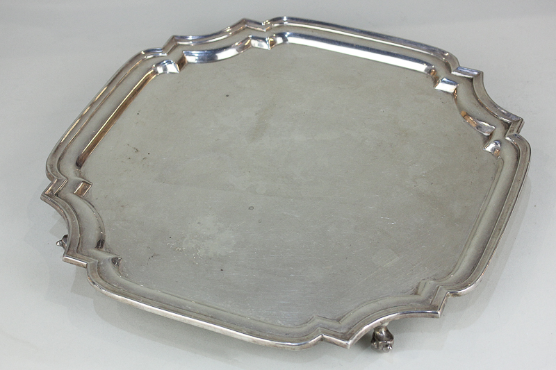 An Elizabeth II silver salver with scalloped corners, on four scroll feet, maker A Chick & Sons,