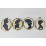 A collection of four oval silhouette profile portraits, of three young ladies and a gentleman,