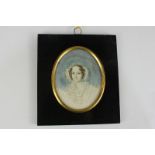 A 19th century oval miniature portrait of a lady, in frilled cap, on ivory, 9.2cm by 7.2cm